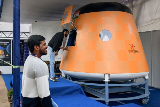 Visitors look at a full-scale model of India's Gaganyaan Orbital Module, a human spacecraft now under development, at the Human Space Flight Expo in 2022.