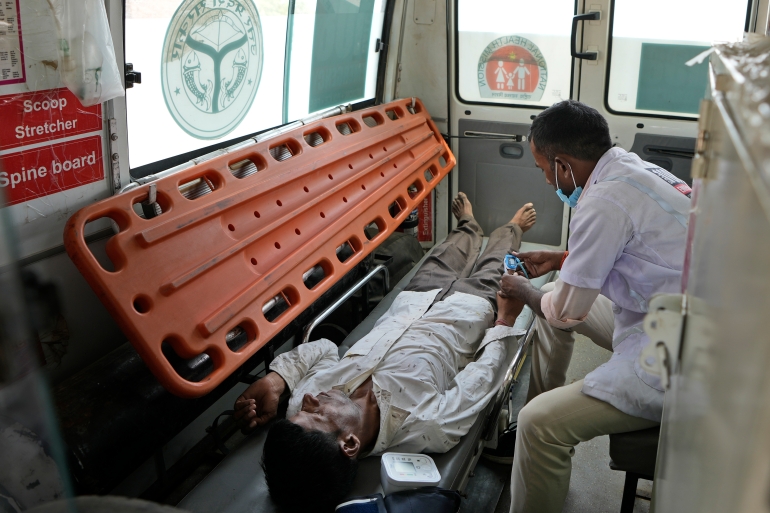 Jitendra Kumar, a paramedic checks the oxygen level of his patient suffering from heat stroke after transporting him by ambulance from his home in Mirchwara village, 24 kilometers (14.91 miles) from Banpur in the Indian state of Uttar Pradesh, Saturday June 16-17, 2023