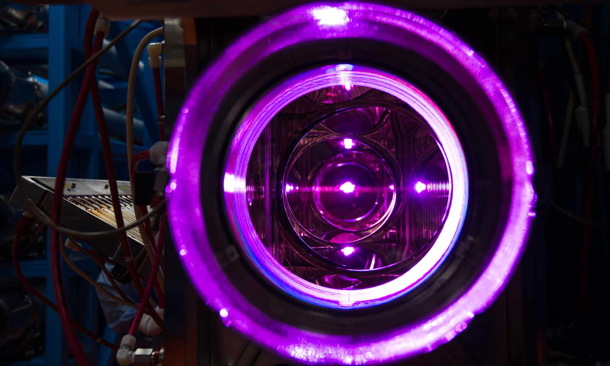 Viewed through the OMEGA laser's 20cm disc amplifiers show several concentric circles of electric purple.